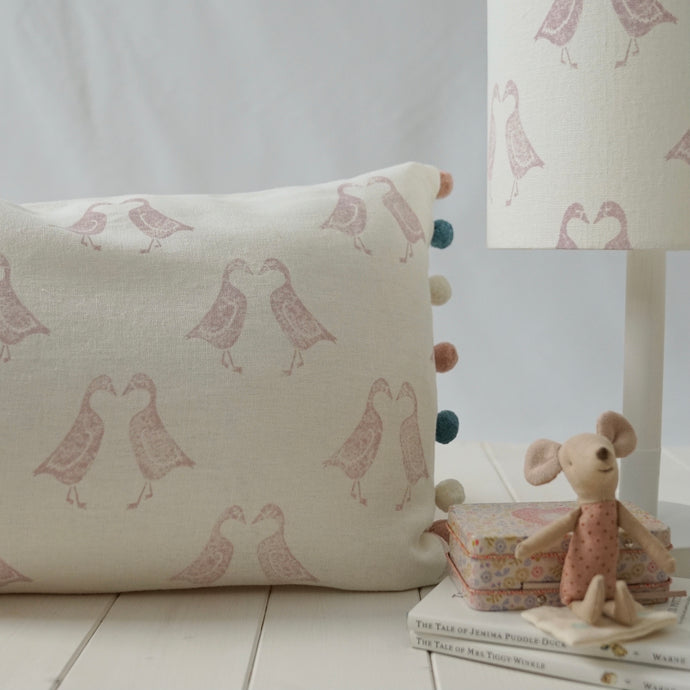 Block printed recycled linen cushion with pompoms - kissing geese design